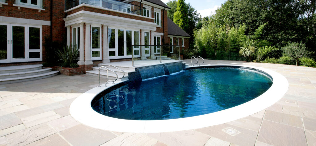 Falcon Pools oval outdoor pool with waterfall feature
