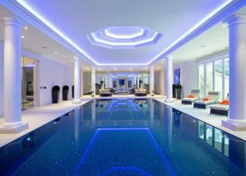 A luxury indoor Falcon Pool with custom pool lighting